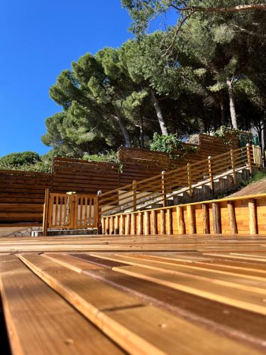 a wooden fence with trees in the background at Il Palazz8 - Dimore di Charme in San Polo dei Cavalieri