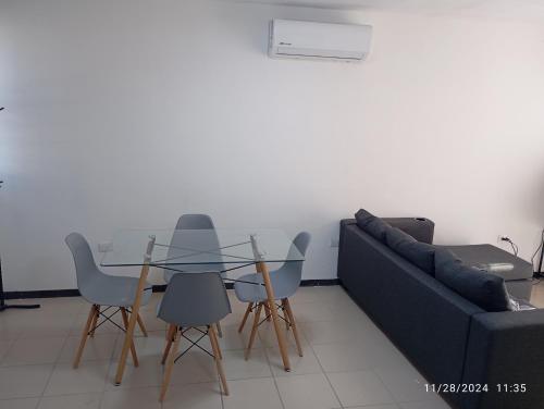 a living room with a glass table and a couch at casa 2 pisos in Pesquería