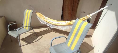 two chairs and a hammock in a room at Casa TIANA in Mindelo