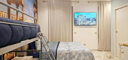 a bedroom with a bed and a tv on the wall at Il Magnifico Superior Rooms 400m from Tiburtina Railway Station and 290m from Metro in Rome