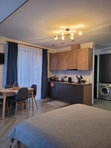 a room with a kitchen and a table and a bed at Eco Village Apartments 4 with terrace in Bakuriani