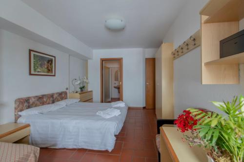 a hotel room with a bed and a couch at TOP Appartamenti in Passo del Tonale