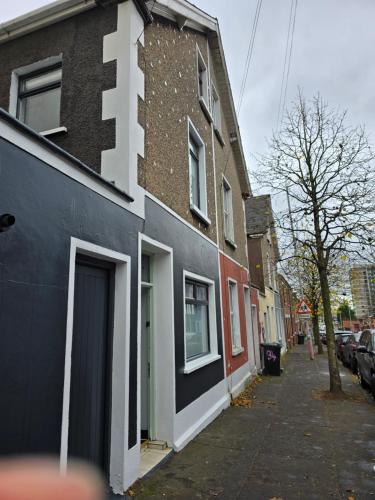 a building on the side of a street at The Big Belfast House Modern 6 Bedroom Townhouse in the Gaeltacht Quarter in Belfast