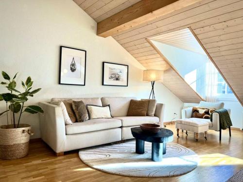 a living room with a couch and a table at Hidden Retreats The GreenAlley in Bern