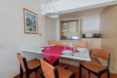 a dining room with a table with a red table cloth at TOP Appartamenti in Passo del Tonale
