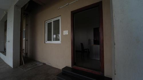 an empty room with a door and a window at Nini Residency codissia stay in Coimbatore