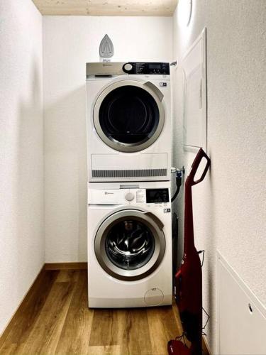 a washer and dryer in a room with a guitar at Hidden Retreats The Lohner in Reichenbach