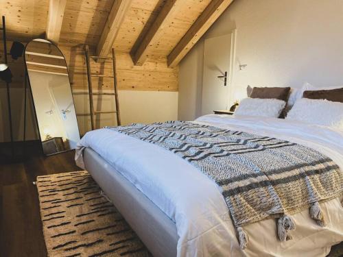 a bedroom with a large bed with a ladder at Hidden Retreats The Lohner in Reichenbach