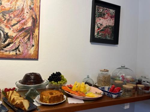 a table topped with plates of food and fruit at Casa Arte Cabore in Paraty