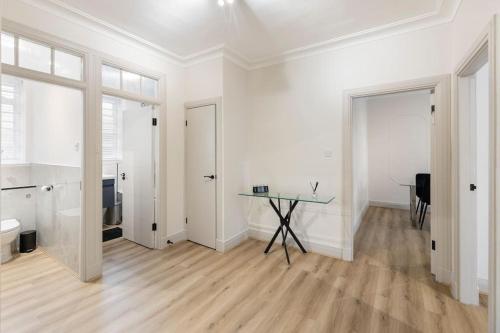 a large white room with a table and a window at Cozy and spacious full size flat in London
