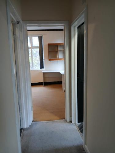 an empty room with a door leading into a room at DB Room near NTU city Campus in Nottingham