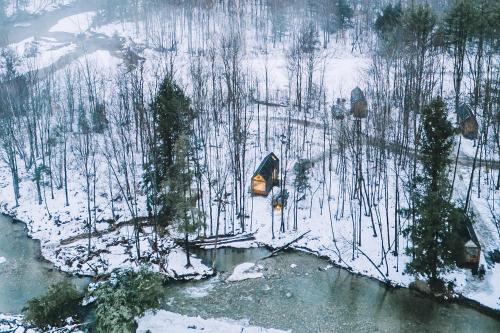 an aerial view of a snow covered forest with a river at Lumen Nature Retreat in Woodstock