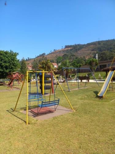 a bunch of playground equipment in a park at Hotel Nascentes da Serra in Poços de Caldas