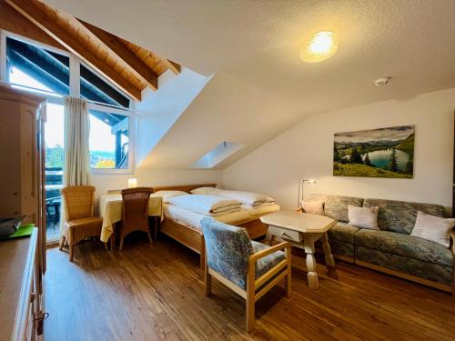 a hotel room with a bed and a couch at Zickenstüble B19 Montana Haus in Oberstdorf