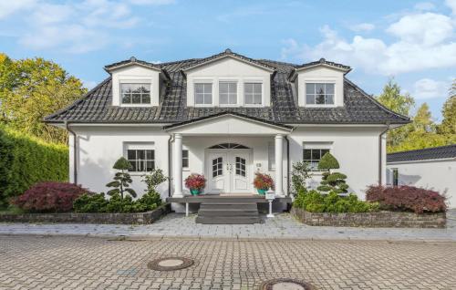 a white house with a black roof at Lovely Home In Dassendorf With Wifi in Dassendorf