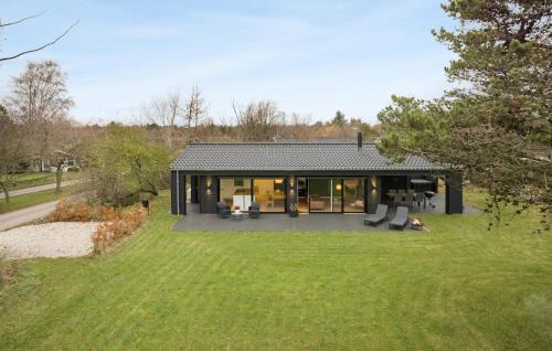 a house with a view of a yard at 3 Bedroom Cozy Home In Gilleleje in Gilleleje