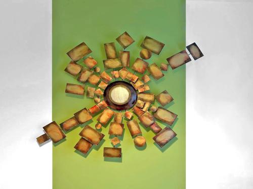 a circular wall decoration on a green wall at Cosy & convenient Consett flat in Consett