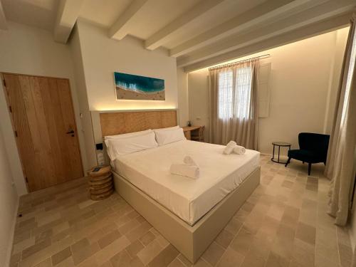 a bedroom with a bed with two towels on it at SetBlaus Boutique Hotel in Ciutadella
