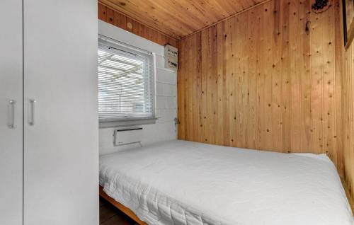 a bedroom with a bed in a wooden wall at Pet Friendly Home In Glesborg With Wifi in Glesborg