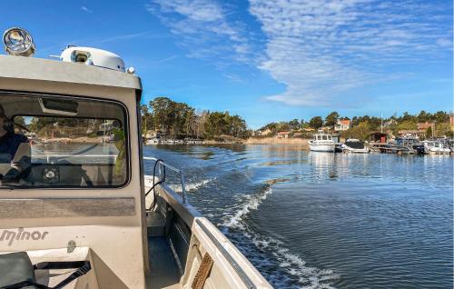 a boat is going down a river at 1 Bedroom Cozy Home In Vikbolandet in Arkösund