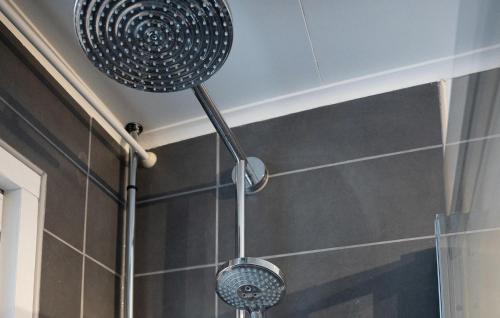 a shower head hanging from the ceiling in a bathroom at 2 Bedroom Lovely Home In Mörlunda in Mörlunda