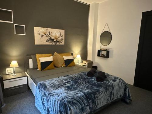 a bedroom with a bed with two cats laying on it at Sea Breeze Retreat - Comfort Apartments in the Heart of Sliema in Sliema