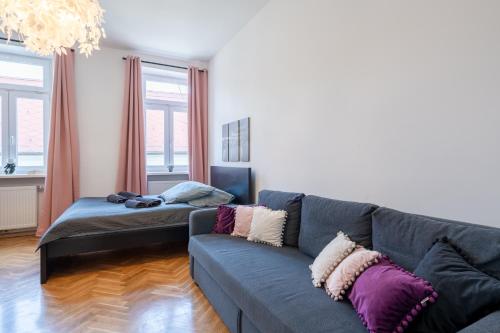a living room with a couch and a bed at revLIVING Apartments Eggenburg in Eggenburg