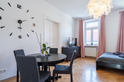 a living room with a table and a bedroom at revLIVING Apartments Eggenburg in Eggenburg