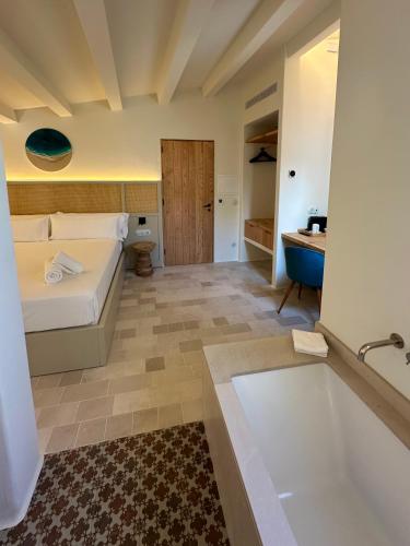 a bathroom with a bed and a tub and a sink at SetBlaus Boutique Hotel in Ciutadella