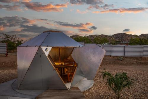 a pyramid shaped building in the middle of a field at Beyond - Walk to Red Dog & Pappy's in Pioneertown