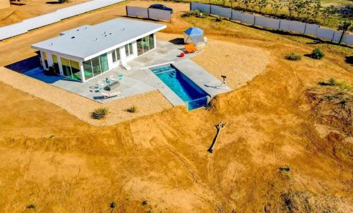 an aerial view of a house with a swimming pool at Beyond - Walk to Red Dog & Pappy's in Pioneertown