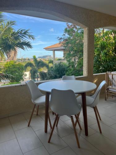 a table and chairs in a balcony with a view at Cocobana 20 - 2 bedroom apartment in Willemstad