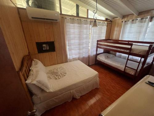 a room with two beds and a bunk bed at Cabana Playa Santa Apto C Piscinas Solar Energy in Guanica