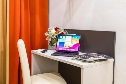 a laptop computer sitting on top of a desk at Hotel Demo' in Milan