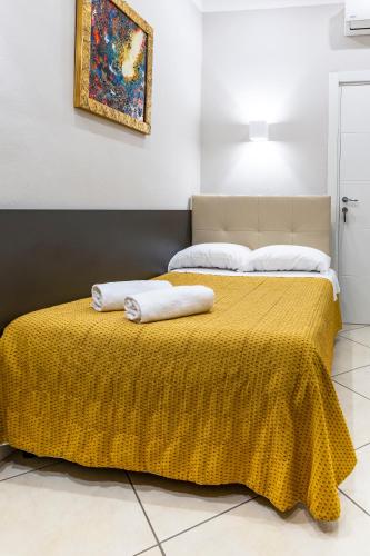 a bedroom with two beds with a yellow blanket at Hotel Demo' in Milan