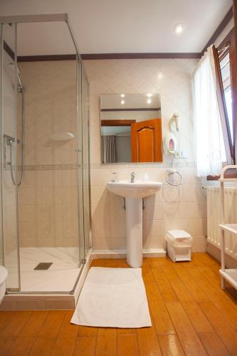 a bathroom with a sink and a shower at CASA RURAL BARAZAR in San Sebastián