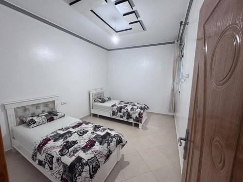 a bedroom with two beds and a skylight at Apartment in Houceima, Ajdir in Ajdir