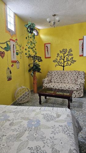 a living room with a couch and a table at Hotel Colonial in Yautepec