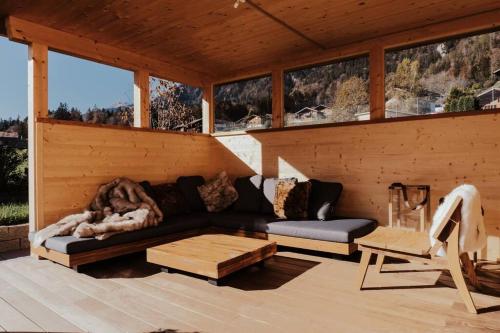 a living room with a couch and a table at Hidden Retreats The MountainHut in Wengi bei Frutigen