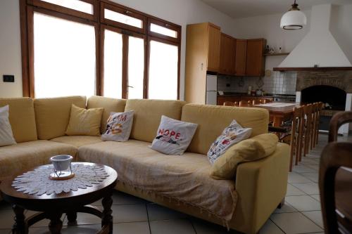 a living room with a couch and a table at il Quadrifoglio camere in stile vintage in Cesena