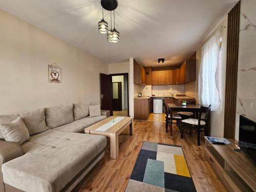 a living room with a couch and a table at Prime Apartments in Bansko