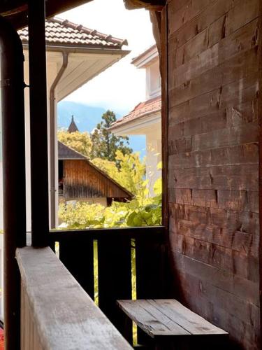 a window of a building with a bench in front of it at Hidden Retreats The Seehof 1 in Oberhofen am Thunersee