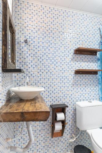 a bathroom with a sink and a toilet at Pousada Flor de Olinda in Olinda
