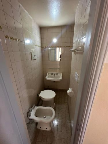 a small bathroom with a toilet and a sink at Recoleta 680 in Buenos Aires