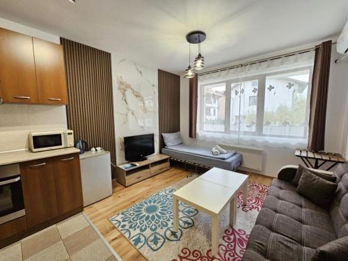 a living room with a couch and a table at Prime Apartments in Bansko