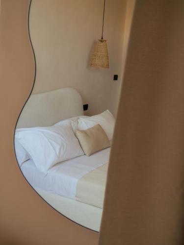a bedroom with a bed with a mirror on the wall at Taga Suites in Catania