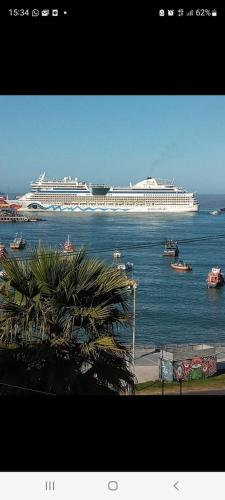 a large cruise ship on the water with a palm tree at HOTEL MELLATTI in San Antonio