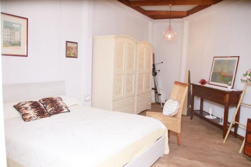 a bedroom with a white bed and a piano at villa lanterna in Conversano