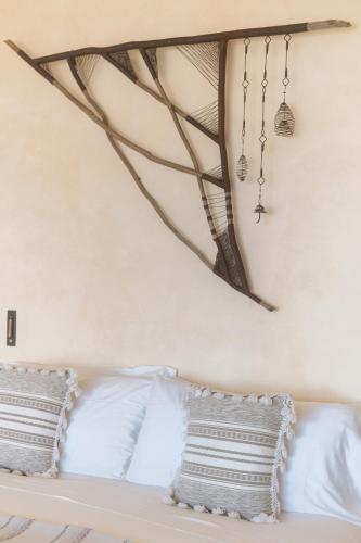 a white bed with two pillows on top of it at Native Residence in Rosarito