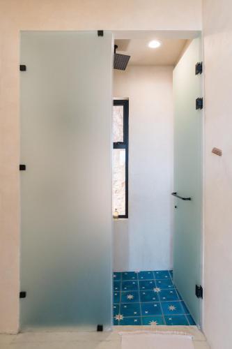 a bathroom with a shower with a glass door at Native Residence in Rosarito